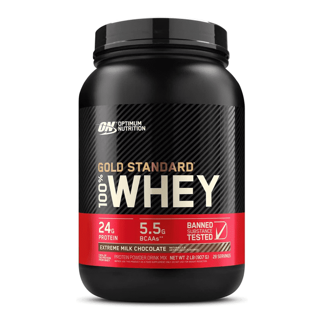suplemento proteico optimum 2 libras extreme milk, tarro frontal negro de 2 lb con etiqueta negra y roja que indica '100% WHEY', 'Gold Standard', '24 g proteína' y '5.5 g BCAAs', logo Optimum Nutrition visible sobre fondo blanco; suele usarse como suplemento alimenticio para complementar dietas.