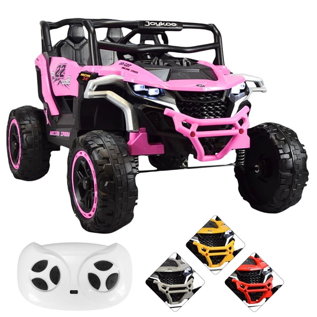 montable eléctrico speed joykoo rosa 12v Vehículo montable infantil rosa 3/4 frontal con carrocería de plástico PP rosa y detalles negros, dos asientos con respaldo y cinturón de seguridad, volante, pedal y parabrisas; ruedas grandes de plástico rígido con aro rosa y luces LED delanteras encendidas; incluye control remoto blanco (control parental), batería 12V y 2 motores, capacidad 30 kg, recomendado 3-6 años. También suele usarse para transportar juguetes pequeños durante salidas cortas.