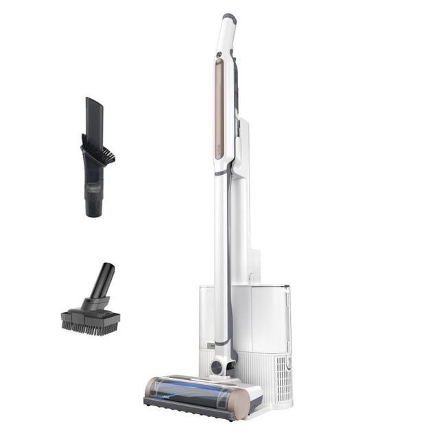 aspiradora inalámbrica con auto vaciado - shark ws642ae. Aspiradora blanca en posición vertical con base de auto vaciado y tubo delgado; cabezal PowerFins visible en la base y dos accesorios a la izquierda: boquilla para ranuras con cepillo y herramienta multisuperficie. Ultra-ligera y ergonómica para uso como aspiradora de mano o vertical, con filtración HEPA y modo silencioso; también suele usarse para limpieza rápida de interiores de autos.
