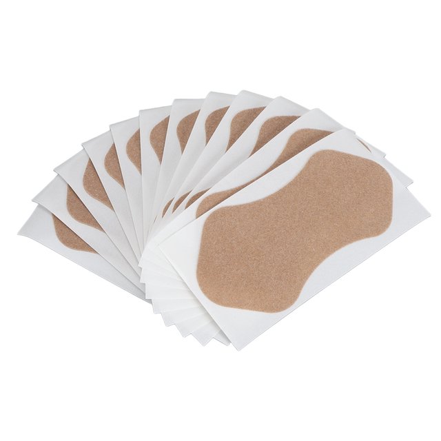 almohadillas para el sudor anggrek 48 piezas parche antitranspirante de tela no tejida, abanico de parches axilares beige sobre papel blanco, forma curvada y superficie absorbente visible en tela elástica que absorbe sudor para proteger la ropa de manchas; también suelen usarse para forrar ropa interior o prendas delicadas durante viajes.