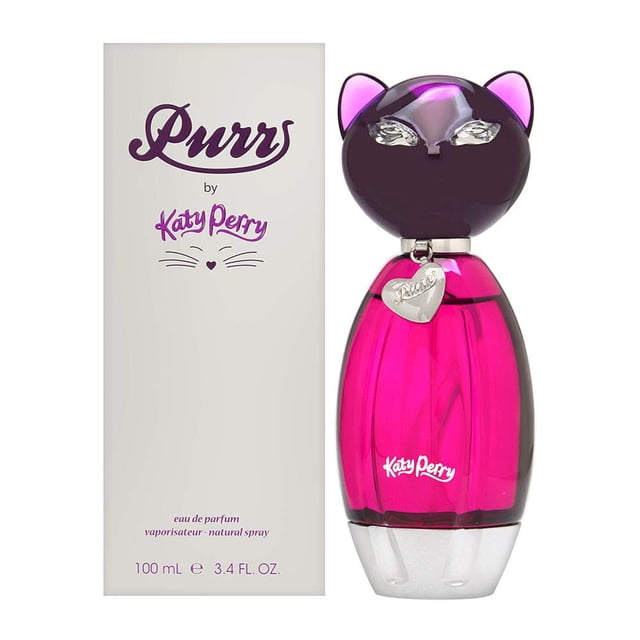 perfume katy perry purr eau de parfum para mujer, 100 ml — Frasco de 100 ml con diseño de gato: tapa negra con orejas y ojos plateados, cuerpo de vidrio rosa fucsia translúcido con medallón en forma de corazón y logotipo "Katy Perry", mostrado junto a la caja blanca con "Purr by Katy Perry" impreso.