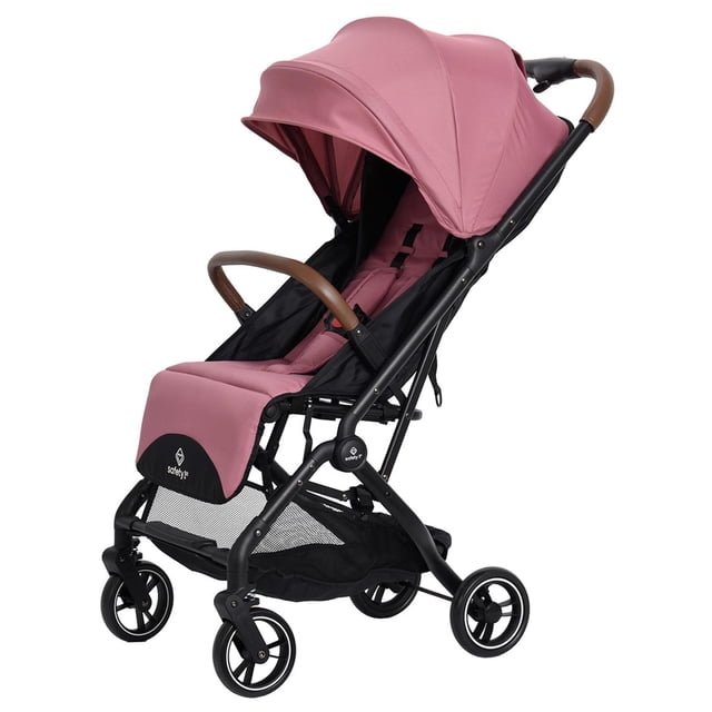 carriola safety 1st slim travel rosa vista 3/4 con marco de acero negro, capota extensible rosa con visor XL, asiento con respaldo y reposapiés ajustables y arnés de 5 puntos; barra frontal removible forrada en café, llantas delanteras giro 360° con suspensión en las cuatro ruedas, canastilla XL y plegado compacto a una mano con barra T para transporte; apta también para traslados urbanos breves por su diseño ligero.
