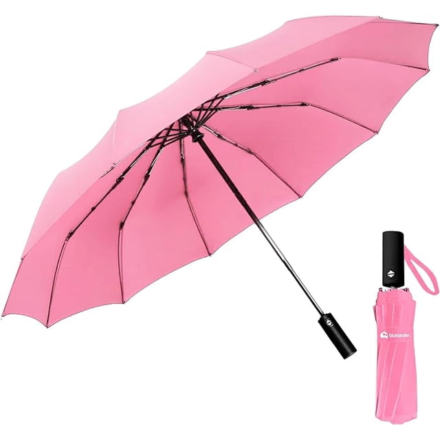 paraguas de bolsillo bluelander rosa plegable y compacto abierto en rosa con varillas negras reforzadas y mango tubular negro; funda rosa con logo BLUELANDER y correa de mano. Resistente al viento y con protección solar, ideal para llevar en bolsa.