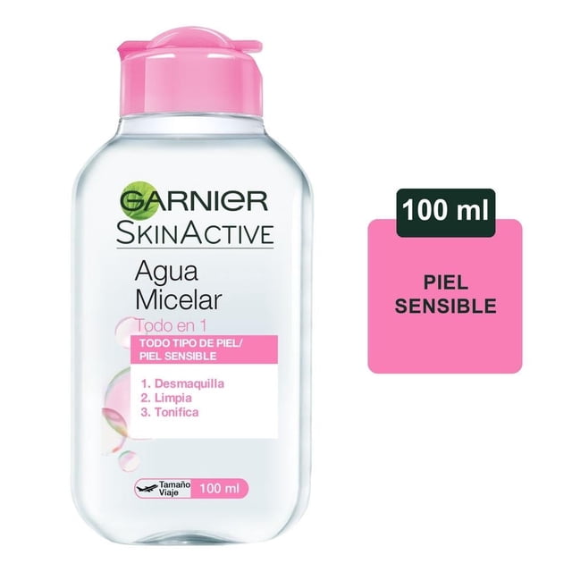 agua micelar garnier skinactive todo en 1 100 ml Botella transparente de 100 ml con tapa rosada; etiqueta blanca y rosa que muestra la marca Garnier SkinActive y texto 'Agua Micelar Todo en 1', lista numerada '1. Desmaquilla 2. Limpia 3. Tonifica' y recuadro que indica 'Piel sensible', formato de viaje; adecuada para limpieza con algodón sin enjuague.
