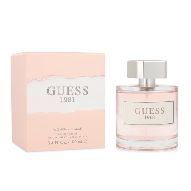 guess 1981 100 ml edt spray Frasco cilíndrico de vidrio 100 ml con líquido rosado y tapa metálica, caja rosa al lado con logo GUESS 1981; familia olfativa almizcle floral amaderado con notas de violeta, jazmín y cedro, lanzamiento 2017. Adecuada para llevar en viajes cortos.