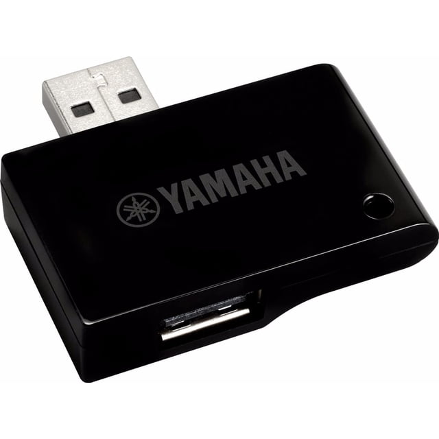 adaptador usb inalámbrico a midi host yamaha para dispositivos ios. Adaptador compacto negro con conector USB tipo A integrado, puerto USB hembra frontal, logotipo Yamaha en la cubierta y un pequeño indicador LED; vista en primer plano. Permite conectar iPhone/iPad vía Bluetooth 4.0 para comunicación MIDI y cargar el dispositivo mientras se usan aplicaciones; también suele utilizarse para controlar teclados o apps de secuenciación en presentaciones en vivo.