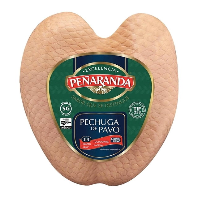 pechuga de pavo peñaranda natural por kilo pieza frontal con forma de corazón y textura cuadriculada rosa pálido; etiqueta verde y dorada PEÑARANDA con recuadro azul “pechuga de pavo” y sellos que indican sin gluten, sin colorantes y sin lactosa; adecuada para comidas balanceadas y que suele usarse en sándwiches fríos o caldos ligeros.