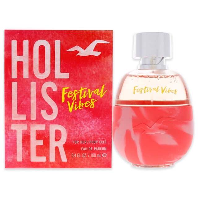 hollister festival vibes for women 3.4 oz eau de parfum spray Vista centrada del frasco y la caja; frasco redondeado de vidrio con base roja y parte superior transparente con tapa plateada, texto dorado "Festival Vibes" en el cuello; caja rectangular roja con logotipo HOLLISTER grande en blanco y texto amarillo Festival Vibes. Fragancia femenina tipo eau de parfum, a menudo usada como pieza de colección personal.