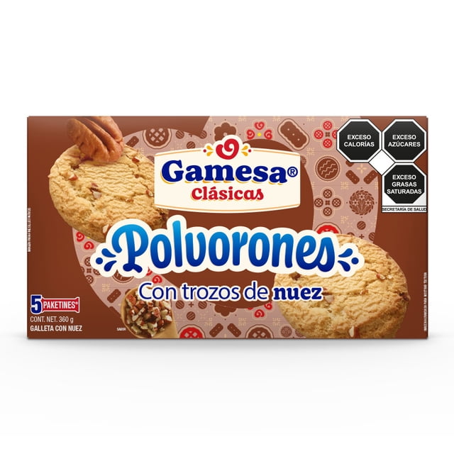 galletas gamesa polvorones sabor nuez 360 g paquete frontal con dos galletas grandes mostrando trozos de nuez, logo Tradiciones Gamesa y texto "Polvorones con trozos de nuez", fondo marrón con patrón de iconos, sellos de advertencia nutricional y mención de 5 paquetines; aptas como snack para acompañar café o té.