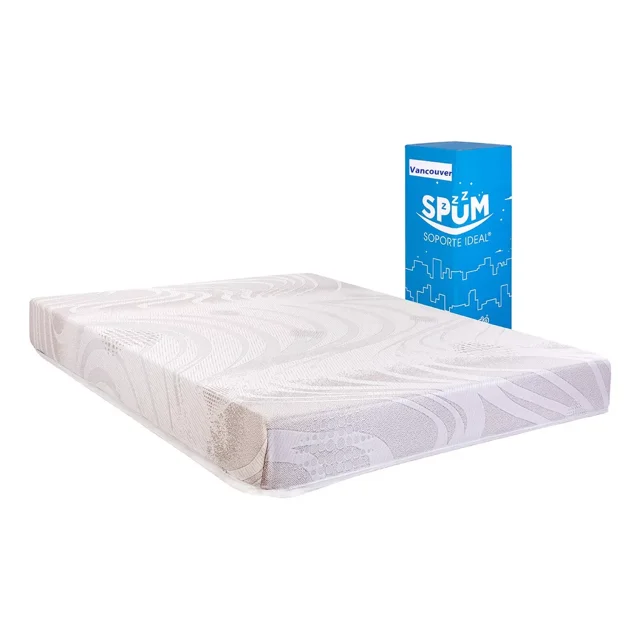colchón en caja matrimonial dormimundo vancouver colchón matrimonial en caja, vista 3/4 frontal con cubierta blanca texturizada y capitoné; borde muestra 3 placas de espuma de poliuretano, base con tela antiderrapante y cubierta anti-ácaros; embalaje azul de la marca al fondo. Diseño ergonómico que evita puntos de presión y movimientos, apto para recámaras con espacio limitado por su formato en caja.