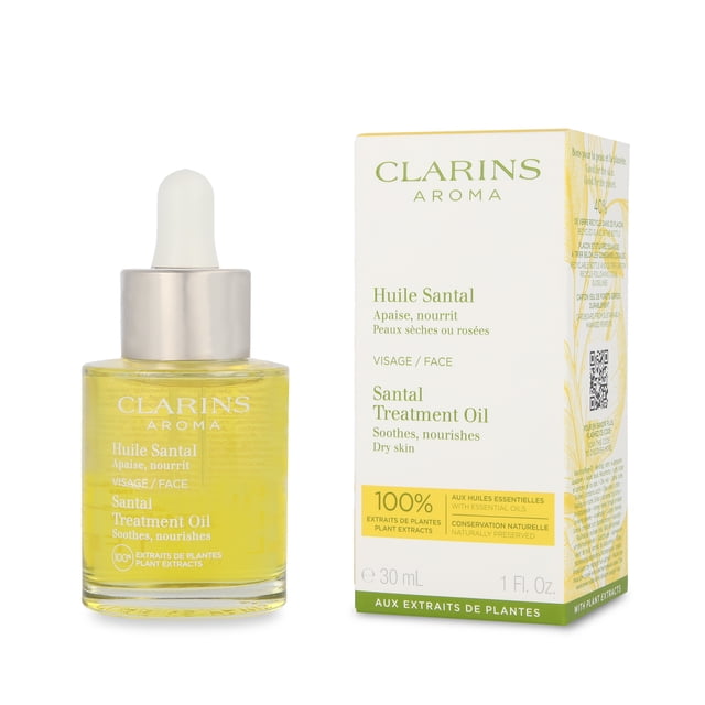 aceite facial clarins aceite facial santal face treatment oil frasco de vidrio con cuentagotas y caja blanca y verde, vista frontal; aceite amarillento con tapa plateada y pipeta blanca, etiqueta "Clarins Aroma Huile Santal" visible y caja con texto en francés e inglés que menciona extractos de plantas y uso para piel seca; adecuado como aceite hidratante y a menudo usado para masaje facial ligero.