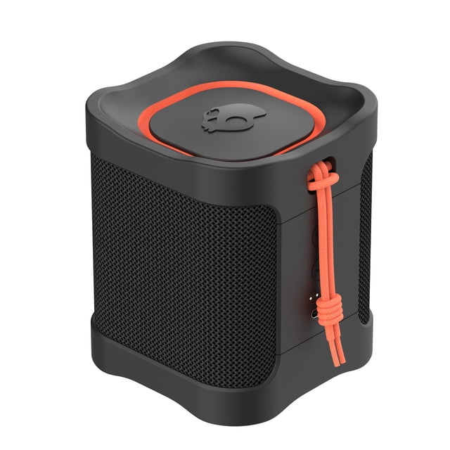 mini bocina bluetooth impermeable terrain skullcandy negro centered front view of a compact cubic portable speaker with black matte housing and black mesh grilles on three sides, top recessed panel with orange trim and Skullcandy skull logo, right side shows orange woven lanyard and three vertical control buttons; suitable as a compact travel speaker.