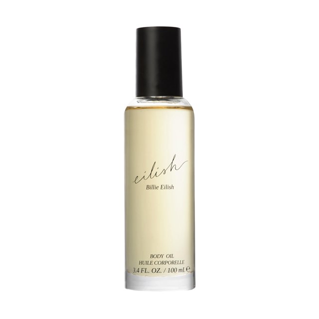aceite corporal billie eilish para mujer 100 ml botella frontal transparente con aceite de tono ámbar claro y tapa negra; etiqueta minimalista con la firma 'eilish', 'Billie Eilish' y 'Body Oil 3.4 FL. OZ. / 100 ml'. Fragancia Amber Gourmand con notas de pétalos azucarados y vainilla cremosa; suele usarse para masaje y cuidado corporal.
