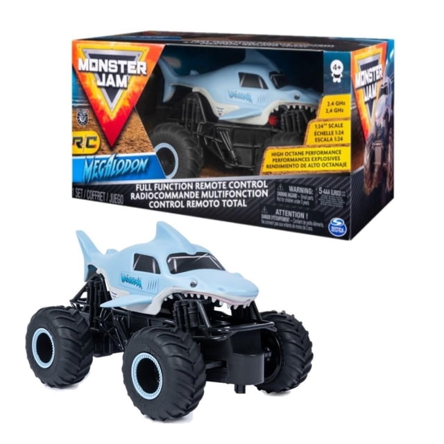 vehículo radiocontrol monster jam spin master megalodon Amarillo — 3/4 frontal del monster truck con carrocería con diseño de megalodón, chasis negro y grandes ruedas todoterreno; caja con logo Monster Jam al fondo. Permite acrobacias y ofrece sensación de manejo realista; requiere pilas AAA; también usado para prácticas en mini pistas.