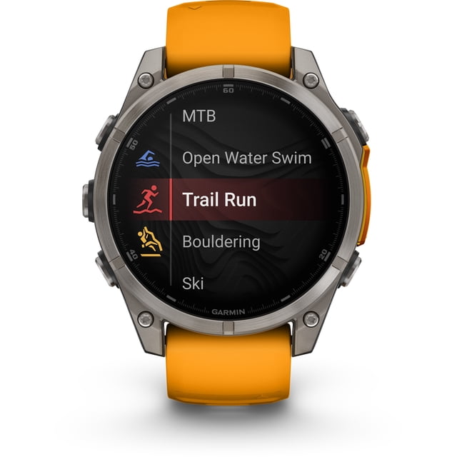 garmin, monitor deportivo, fenix 8, 47mm, amoled, sapphire orange Smartwatch multideporte 47 mm, vista frontal centrada con bisel metálico y correa naranja; pantalla AMOLED muestra menú de actividades con 'Trail Run' resaltado; también apto para registrar entrenamientos al aire libre.