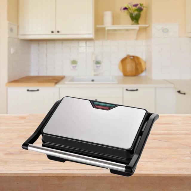 panini press grill parrilla eléctrica para interiores 750w compact touch handle desayuno sandwichera para hamburguesas filete queso a la parrilla Parrilla eléctrica compacta en negro y acero inoxidable, vista frontal centrada; tapa pulida con indicador LED, mango tubular anti‑escaldado, borde de la placa interior con recubrimiento antiadherente y cuerpo de PP resistente, superficie de cocción 11 x 9 pulgadas según especificaciones, colocada sobre una encimera de cocina; adecuada para preparar sándwiches, hamburguesas y filetes y a menudo usada como opción portátil para desayunos.