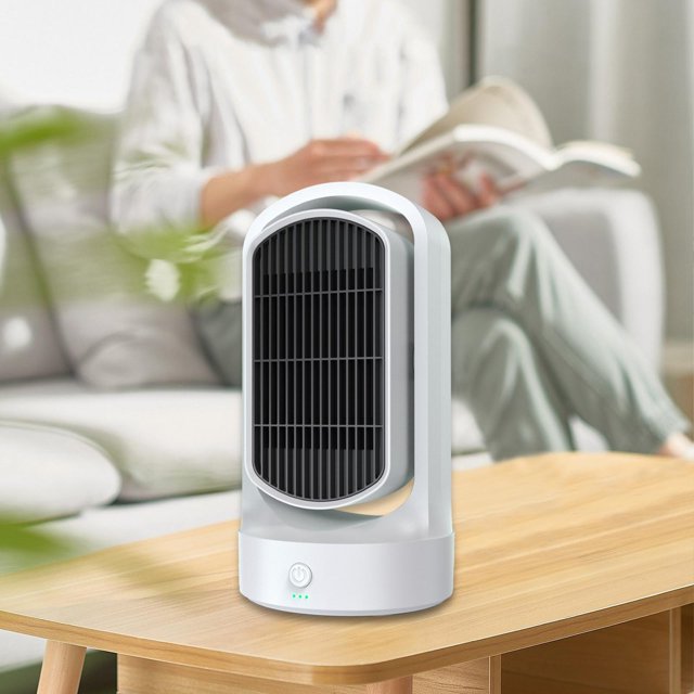 calentador portátil, ventilador calefactor doméstico, 3 modos de ajuste, calefacción ptc, calentador de escritorio silencioso, calentador eléctrico blanco blesiy calentadores espaciales Producto de importación: vista frontal en 3/4 de un calentador de escritorio blanco BLESIY con rejilla frontal oscura, asa superior integrada y base circular con botón táctil iluminado y tres indicadores LED, cuerpo de plástico blanco sobre mesa de madera en sala con persona desenfocada leyendo al fondo. Apto para uso interior en escritorio, oficina o dormitorio; protección contra sobrecalentamiento PTC y apagado automático por vuelco. Tamaño aproximado 27.5 x 10.2 x 14.5 cm.