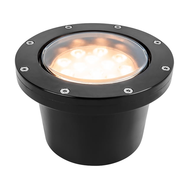lampara empotrado en piso negro 12w luz suave cálida 12hled Lámpara de piso empotrable exterior negra, vista 3/4 frontal; aro circular con ocho tornillos visibles y lente central que muestra LED integrado emitiendo luz suave cálida. Especificaciones en ficha: 12 W, IP65, IK06 y corte de empotramiento 14.2 cm. Apta para andadores, muelles y zonas costeras; también suele usarse para delimitar pasos en terrazas pequeñas.
