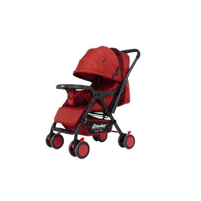 carriola reversible the baby shop plegable, reclinable, reversible y frenos rojo carriola roja vista 3/4 con manubrio reversible, chasis negro y toldo con ventana. Respaldo reclinable en 3 posiciones, piecero ajustable, charola frontal desmontable, canastilla inferior amplia y llantas dobles con freno en las cuatro ruedas; plegado rápido con una mano. Recomendada 3–36 meses; suele usarse también para paseos urbanos y viajes cortos.
