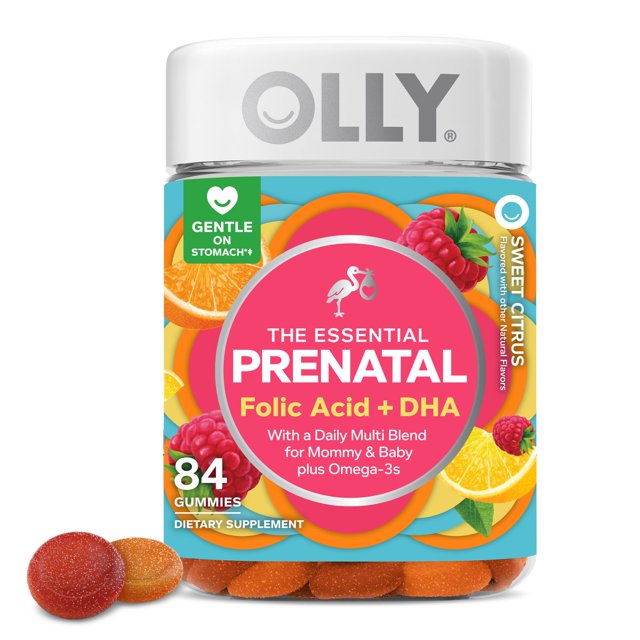 multivitamínico gomoso prenatal olly essential 84 citrus berry Frasco frontal centrado con etiqueta turquesa y rosa que indica Folic Acid + DHA; frasco transparente con 84 gomitas naranja rojizas visibles, ilustraciones de naranja y frambuesa y tapa blanca con logo OLLY. Sabores cítricos y baya.