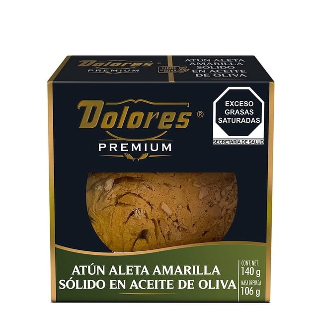 atún dolores premium aleta amarilla en aceite de oliva 140 g empaque frontal cartonado negro y dorado con ventana que muestra bloque de atún sólido en aceite, marca Dolores Premium arriba, sello de advertencia nutricional y rótulo verde con contenido neto 140 g; también usado frecuentemente como conserva para ensaladas o tacos.
