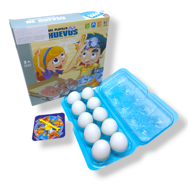 juego de mesa interactivo platillo de huevos vianos limited vista 3/4 de la caja ilustrada junto a una bandeja azul con ocho cápsulas blancas y una ruleta giratoria; juego de mesa para 2–6 jugadores cuyo objetivo es no salpicarse con agua según la casilla de la ruleta, también suele usarse para dinámicas de fiesta y reuniones familiares.