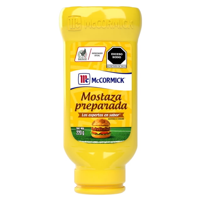mostaza mccormick preparada 220 g botella invertida de plástico amarillo con tapa de rosca; etiqueta frontal con logo McCormick, texto 'Mostaza preparada', pictograma de hamburguesa y sello 'Exceso sodio'; neto 220 g. Vista frontal, envase centrado sobre fondo blanco; ideal para marinar pescados y mariscos.