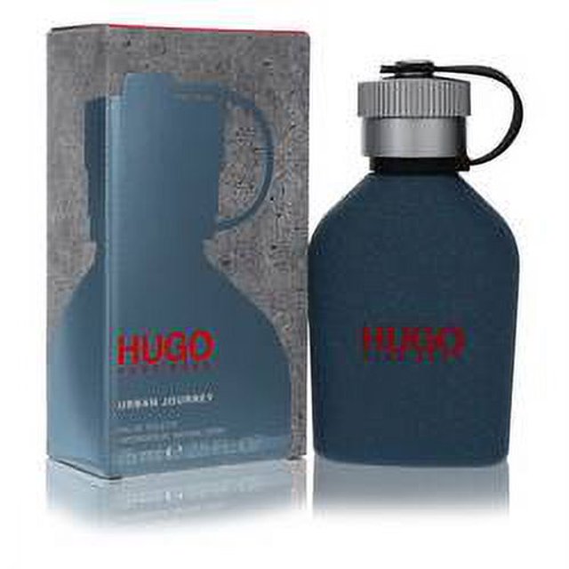 hugo urban journey eau de toilette spray hugo boss Frasco azul oscuro mate con tapón plateado tipo cantimplora y logo rojo HUGO BOSS en el frente, caja con diseño impreso a la izquierda; colonia masculina de uso diario con notas verdes y florales según especificación del producto.