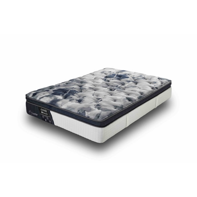 colchón king size lester cool - línea ever cool - híbrido con memory foam gel y resortes lfk - siempre fresco, vista 3/4 de colchón king size sin ropa, superficie acolchada con patrón jaspeado gris y azul, borde con ribete azul marino y etiqueta frontal Lester, paneles laterales blancos texturizados y base gris oscuro que muestra la unión de capas. A menudo usado para probar almohadas y ropa de cama por su perfil alto.
