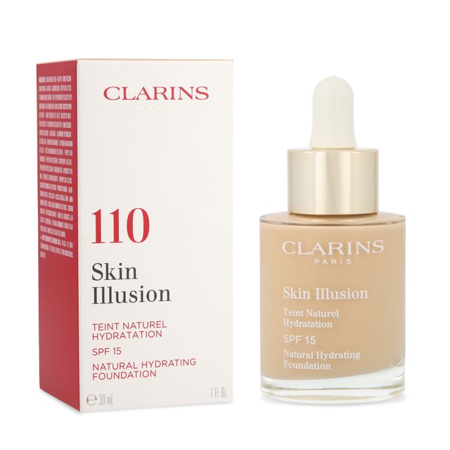 base de maquillaje skin illusion clarins honey botella de vidrio de 30 ml con cuentagotas y dosificador dorado junto a su caja marcada con 110; maquillaje sérum ligero para efecto piel desnuda, acabado natural y etiqueta 'Skin Illusion' visible, fondo blanco.