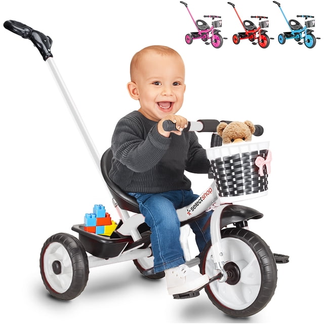 triciclo bicicleta juguete para niños infantil cesta cajuela color Negro SELECTSHOP; vista 3/4 frontal con niño sentado, asiento con respaldo, manubrio con canasta blanca tipo trenzado y lazo rosa, pedales frontales, ruedas grandes, barra posterior para empujar y cajuela bajo el asiento; a menudo se usa para paseos cortos supervisados.