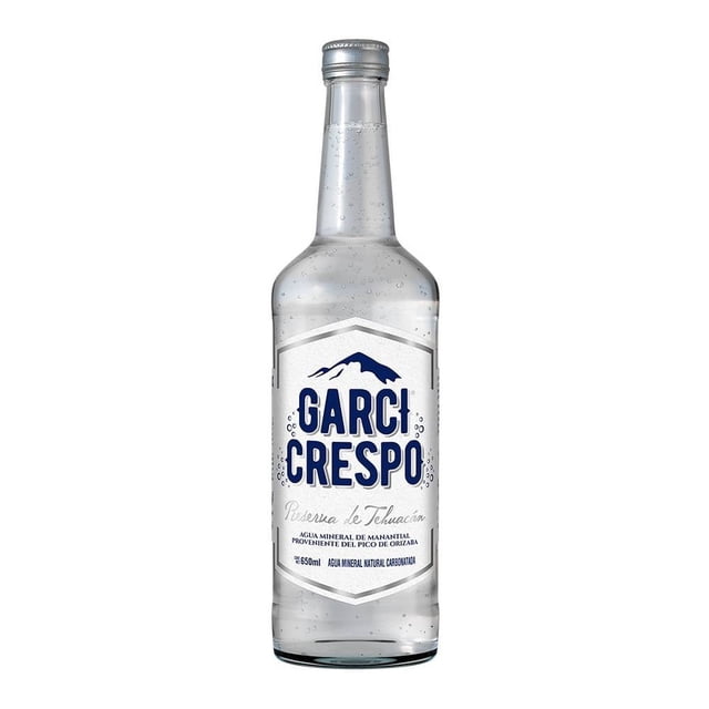agua mineral garci crespo reserva de tehuacán de manantial 650 ml botella frontal transparente con etiqueta blanca y logo azul Garci Crespo, texto 'Reserva de Tehuacán', tapa plateada y burbujas visibles; ideal para despensa y bebidas para hidratar en casa.