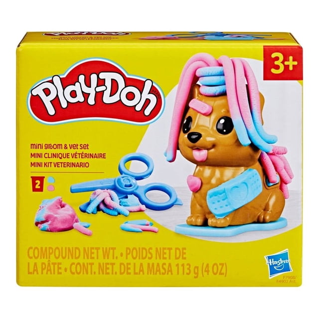 set de juego hasbro play-doh mini kit veterinario caja frontal con cachorro de plastilina marrón sentado, pelo rosado y azul formado al presionar la figura sobre la base, incluye tijeras y accesorios moldeadores azules, indicador 3+ y peso de masa 113 g; también suele usarse para juegos de rol veterinario y prácticas de motricidad fina.