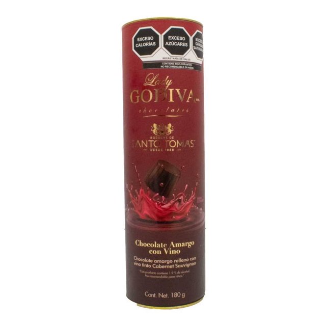 chocolate amargo la suiza lady godiva rellenos con vino tinto cabernet sauvignon 180 g envase cilíndrico frontal, tubo rojo con logo Lady Godiva y texto "Chocolate Amargo con Vino" y peso 180 g; ilustración de bombón con salpicadura roja que sugiere relleno de cereza al licor y sellos de advertencia nutricional en la parte superior; adecuado para regalar o compartir.