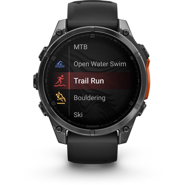 garmin, monitor deportivo, fenix 8, 47mm, amoled, glass, slate gray reloj inteligente multideporte 47 mm con pantalla AMOLED redonda mostrando menú de actividades (Trail Run resaltado), caja gris pizarra, bisel metálico y correa negra visible; muestra iconos de natación, MTB y esquí. A menudo usado para registrar rutas y entrenamientos al aire libre.
