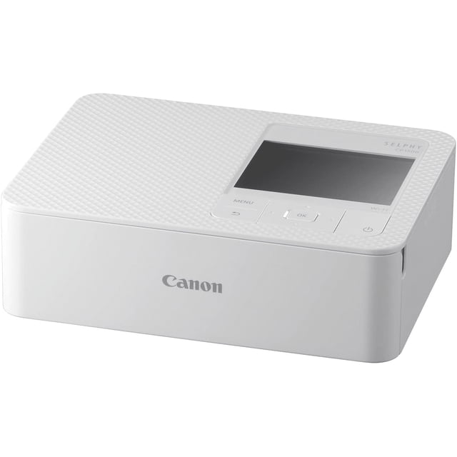 foto impresora canon selphy cp1500 portatil color transferencia termica wifi canon selphy cp1500_w impresora fotográfica blanca, vista frontal 3/4 con superficie texturizada, pantalla LCD de 3.5" y botones físicos; salida frontal y logo Canon visibles; soporta tamaños Postal 4.0" x 6.0" y tarjeta 2.1" x 3.4", conexión USB, Wi‑Fi y ranuras SD/SDHC/SDXC.