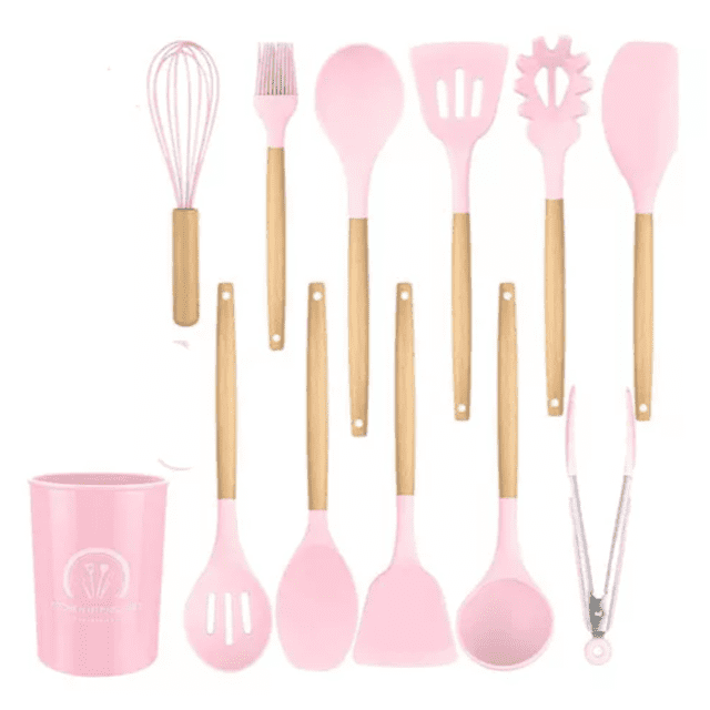 juego utensilios de cocina kitchen home rosa madera de silicona 12 pza — Conjunto de 12 utensilios con cabezas de silicona rosa y mangos de madera: batidor, brocha, cuchara, espátula ranurada, espátula para pasta, espátula plana, cuchara ranurada, cucharón, pala, pinzas con puntas de silicona y vaso portautensilios rosa; vista frontal alineada sobre fondo blanco y mangos con orificio para colgar. También adecuado para organizar utensilios de repostería en estantes pequeños.