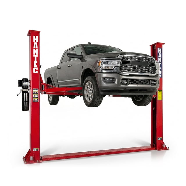 rampa hidráulica automotriz 2 postes hantec 10,500 lbs 220v rojo Vista frontal de la rampa Hantec en rojo elevando una camioneta gris; postes verticales con logo, travesaño inferior, brazos asimétricos con pads de apoyo visibles, unidad hidráulica lateral con depósito de 12L, altura de levante 1,800 mm y capacidad 4.7 toneladas; adecuada para mantenimiento de pickups y autos ligeros.