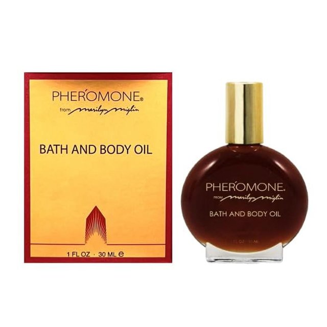 aceite de baño y cuerpo marilyn miglin pheromone® 30 ml Frasco redondo de vidrio ámbar con tapa dorada y etiqueta PHEROMONE; caja amarilla con borde rojo y texto Bath and Body Oil, indicado para baño o masaje suave y apto también para usar como aceite de perfume en puntos de pulso.