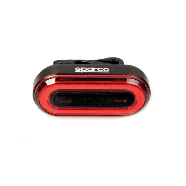 sparco luz trasera led recargable 50 lúmenes impermeable para bicicleta — frontal, luz trasera negra con lente roja ovalada y logo Sparco; carcasa de aluminio y ABS, clip de fijación posterior y puerto de carga USB integrado; compacto y ergonómico para montaje rápido sin herramientas en sillín o tija, seis modos de iluminación y batería recargable 400mAh; ideal para ciclismo urbano y nocturno y adecuada para bicicletas plegables en viaje.