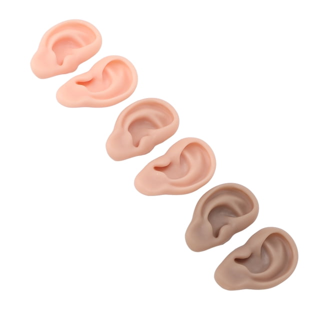 modelo de oreja anggrek silicona 3 pares color claro medio oscuro, seis modelos anatómicos de oreja en diagonal en tres tonos (claro, medio, oscuro), textura suave y tamaño aprox. 7.5 x 4.5 x 1.7 cm, para práctica de perforación, sutura y exhibición de aretes.
