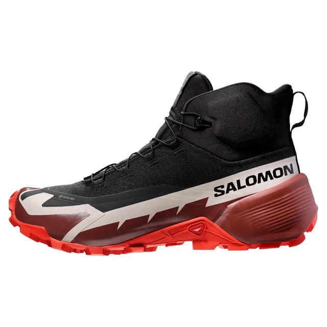 bota caballero salomon cross hike mid gore tex 2 l41735900 negro 30 bota de media caña perfil lateral derecho con caña envolvente y tirador posterior. Parte superior negra sin costuras en malla y material sintético, puntera y refuerzo de goma contra piedras, suela roja con tacos agresivos y logotipo SALOMON en el costado. Membrana Gore‑Tex impermeable indicada; suele usarse también como bota de aproximación para viajes cortos.