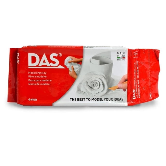cerámica fría das blanca 500 g paquete rectangular de pasta para modelar blanco con envoltura roja y logo DAS, vista frontal centrada que muestra una rosa y un vaso modelados en la ilustración del empaque; recomendada para manualidades y trabajos escolares, endurece al aire y tiene textura fina.